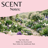 Scent Notes graphic featuring a pink top and bottom with a central garden scene. The text lists fragrance notes: Top: Violet, Rose; Middle: Lily, Floral Accords; Base: Amber, Iris, Sandalwood, Musk.