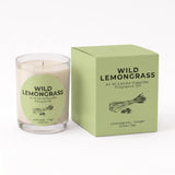 A glass jar candle with a pale green label next to its matching light green box, both printed with the brand name Wild Lemongrass and the scent name Lemongrass - Ginger Green Tea.