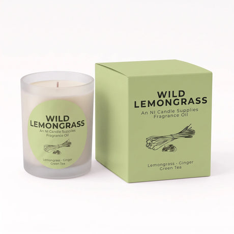 A Wild Lemongrass fragrance oil candle in a frosted glass jar next to its light green cardboard packaging box, on a clean white background.