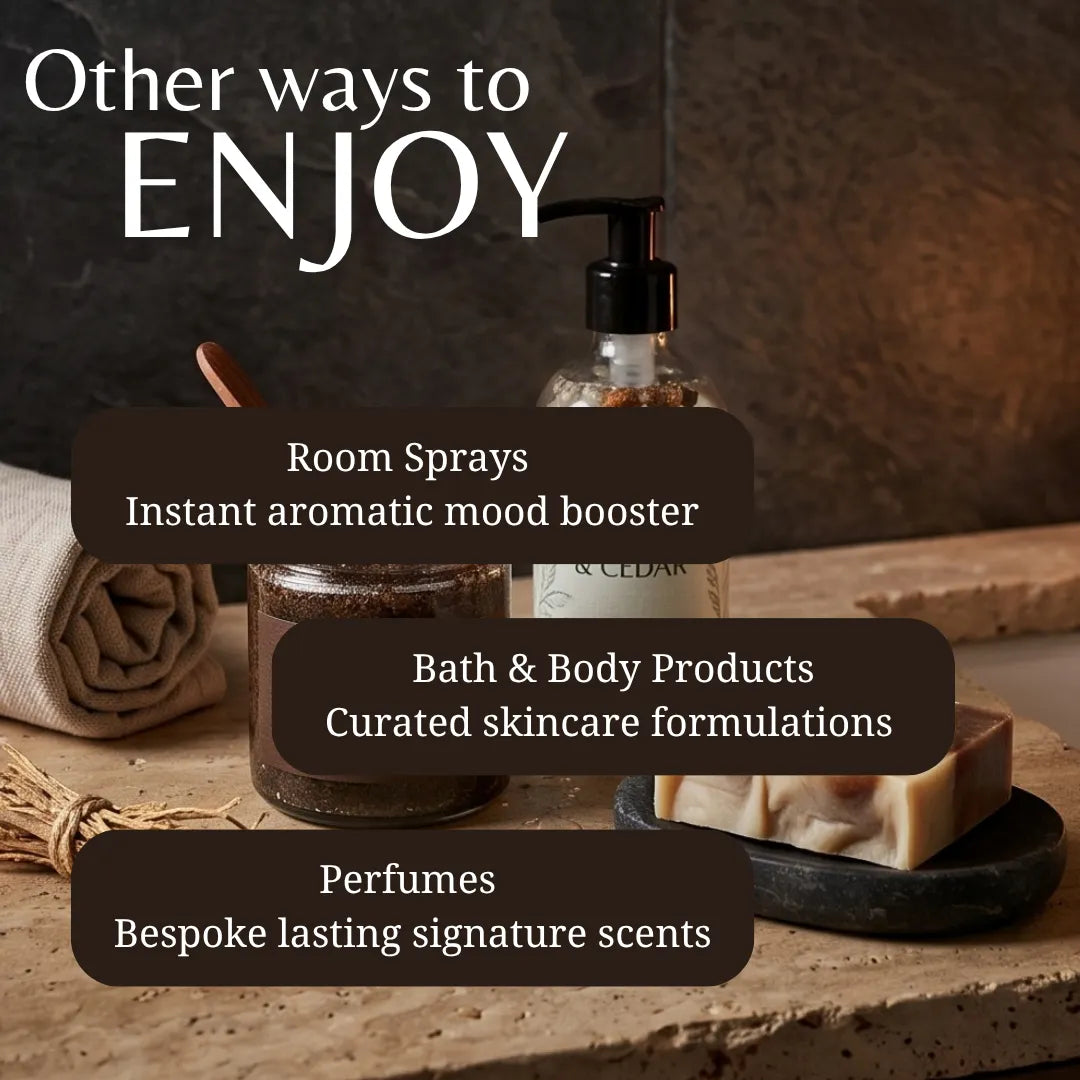 Promotional graphic for a collection of home and body products, featuring a clear pump bottle, a jar, a rolled towel, and a bar of soap on a rustic stone surface. White text at the top reads 'Other ways to ENJOY' with three dark brown text boxes listing 'Room Sprays', 'Bath & Body Products', and 'Perfumes'.
